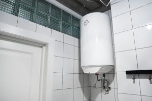 tankless hot water heater on wall in bathroom to ensure hot water no matter what.