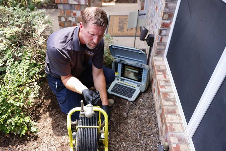 Licensed plumber diagnosing a drain blockage in Duncanville, TX